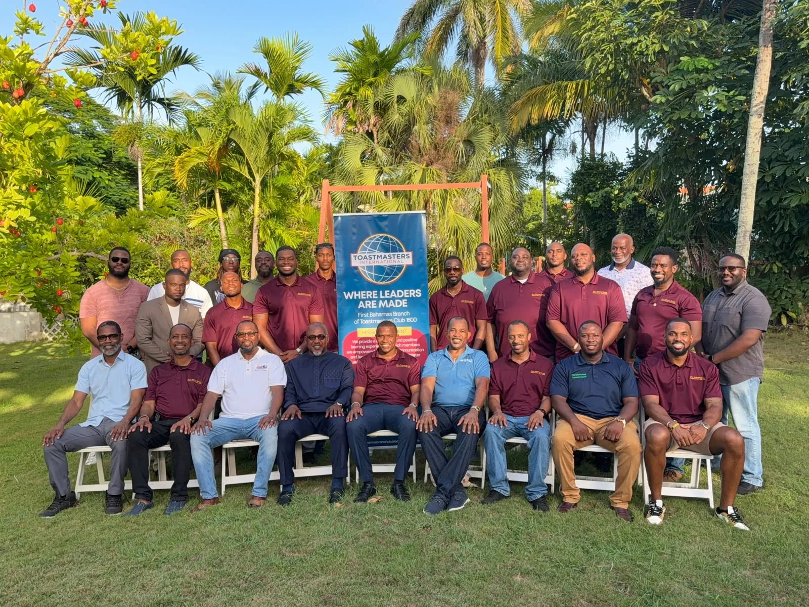 Club 1600 members gathered with a Toastmasters International banner